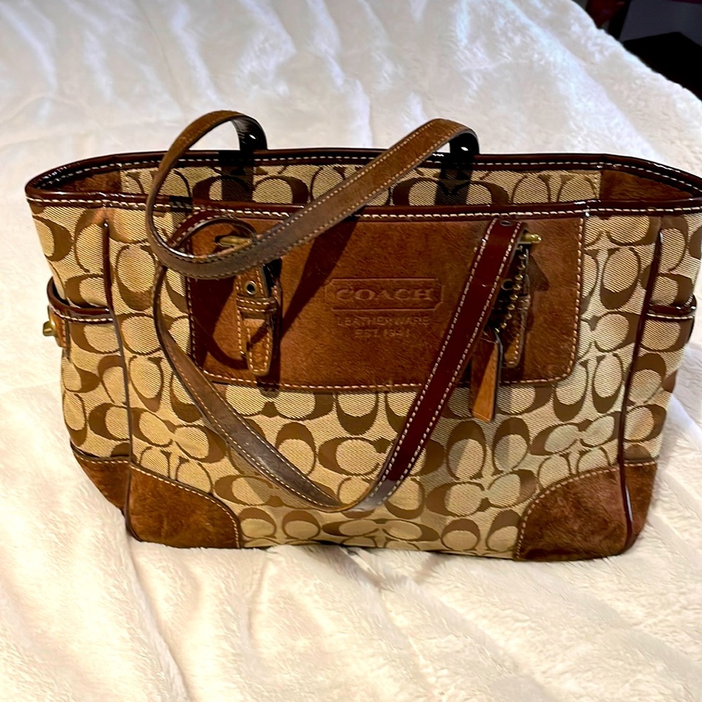Coach signature purse with brown suede accents.
